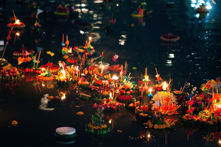 Piccole offerte galleggianti (Krathong) illuminate sull'acqua per il festival Loy Krathong